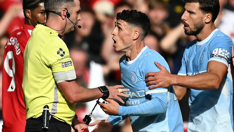 Phil Foden reacts after being shown a red card by referee Michael Oliver