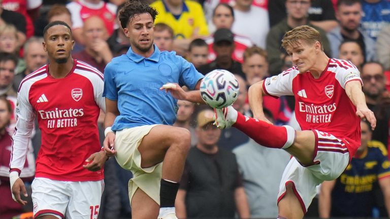Martin Odegaard battles to win possession during Arsenal's Premier League clash with Brighton