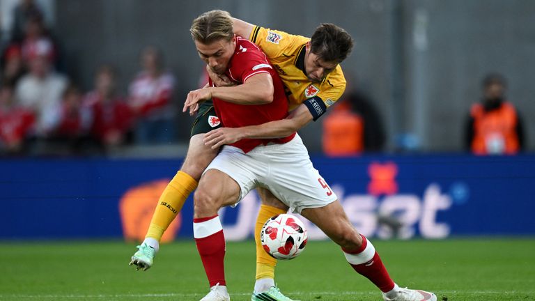 Denmark's Rasmus Hojlund is challenged by Ben Davies of Wales