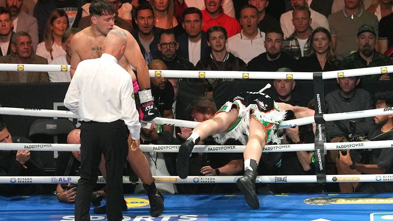Carty falls through the ropes after receiving a blow to the back of the head from Allen