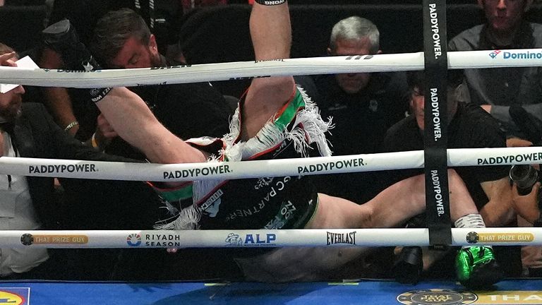 Thomas Carty falls through the ropes during the first round of his fight with David Allen