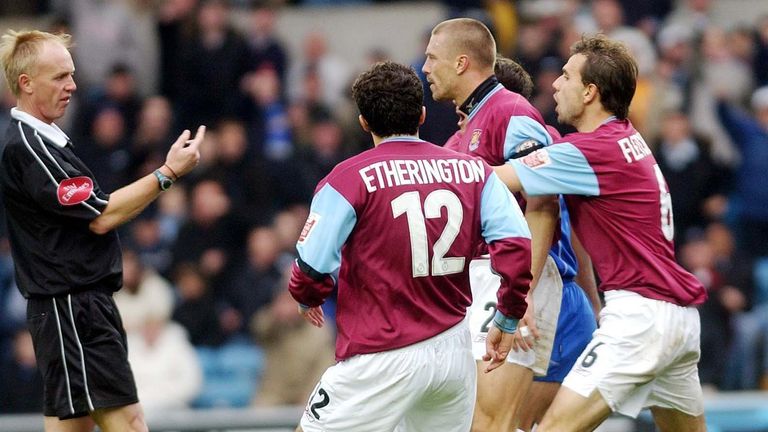Referee Peter Walton books West Ham's Tomas Repka during the 1-0 loss at Millwall in November 2004