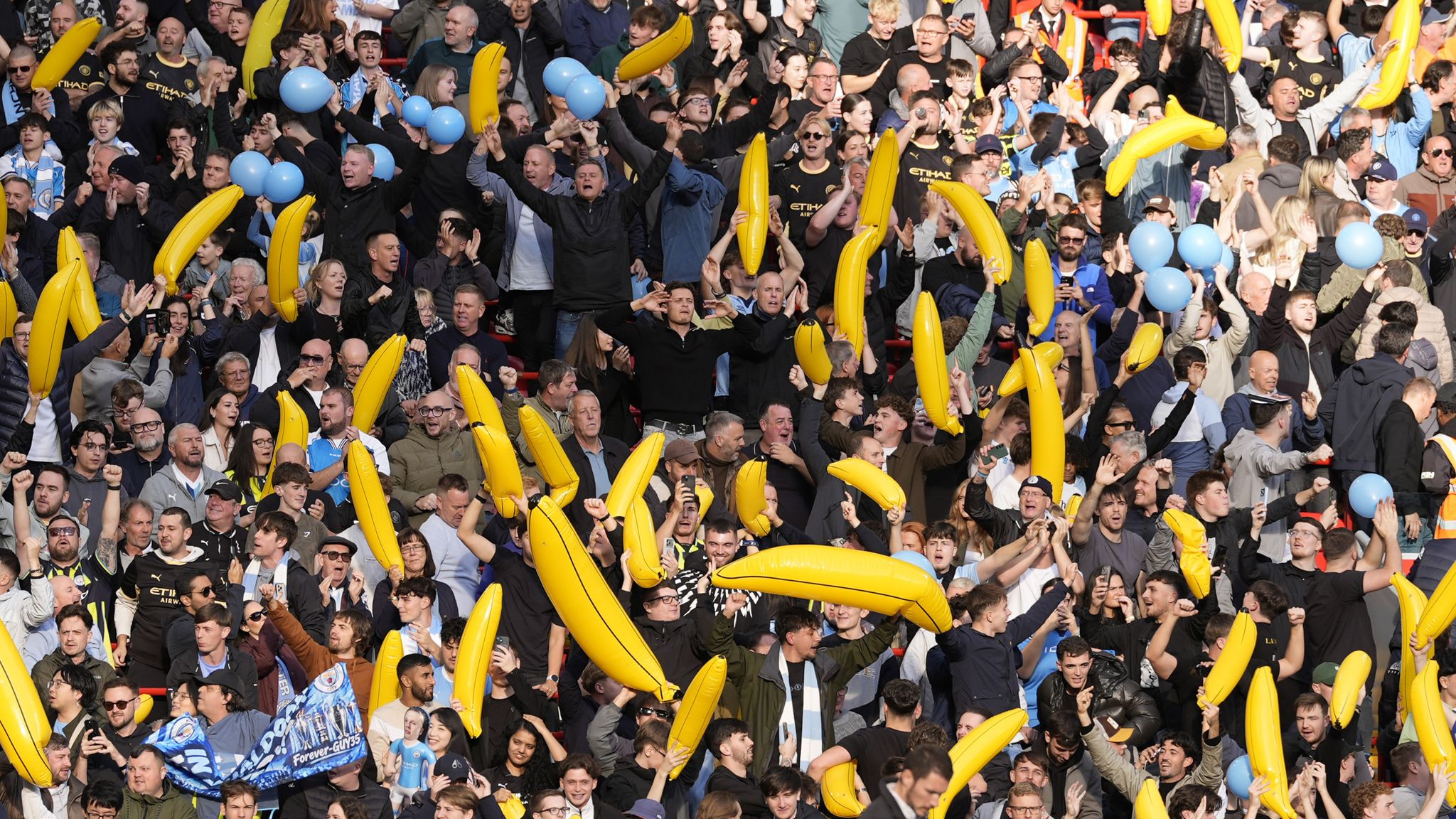 Man City fans wave inflatable bananas during their win over Liverpool at Anfield