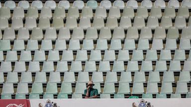A cricket supporter sits alone in the stands during the first Test between South Africa and Australia in Durban