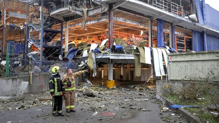 Rescuers work at a site of a shopping mall for household items which was hit by a Russian missile attack, amid Russia's attack on Ukraine, in Kyiv, Ukraine October 22, 2026. REUTERS/Gleb Garanich