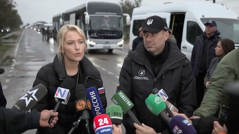 Russia's Yana Lantratova and Ukraine's Dmytro Lubinets, human rights officials, meet in front of Oleshky buses. Pic: Yana Lantratova/Reuters