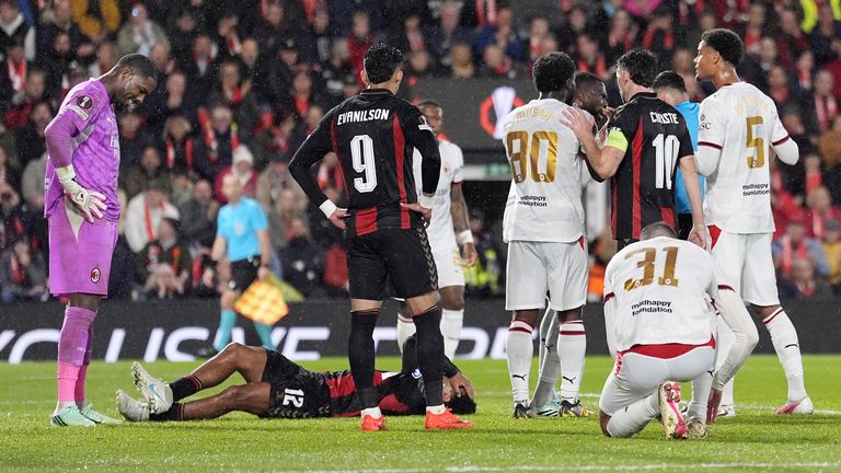 AC Milan goalkeeper Mike Maignan looks at Tyler Adams as he is sent off for a push to the face of the Bournemouth player