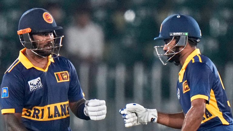 Sri Lanka's Avishka Fernando, left, celebrates with Pavan Rathnayake after hitting a boundary during the tri-series