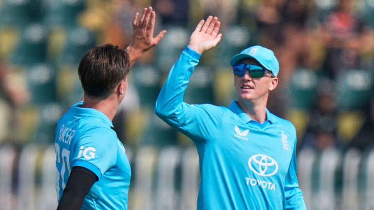 England's Sonny Baker, center, celebrates with teammates after taking the wicket of Pakistan's Saim Ayub, left, during the tri-series one-day international cricket match between Pakistan and England, in Rawalpindi, Pakistan, Tuesday, Oct. 20, 2026. (AP Photo/Anjum Naveed)