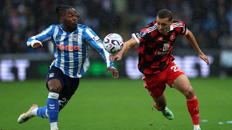 Brandon Thomas-Asante of Coventry City and Timothy Castagne of Fulham battle for possession