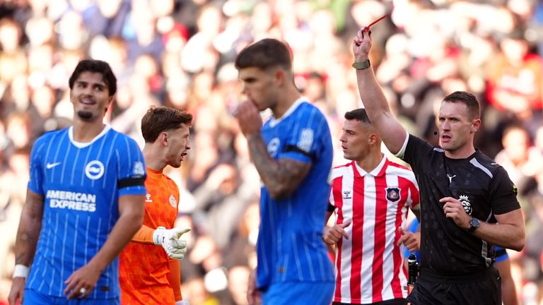 Referee Thomas Bramall shows a red card to Brighton defender Pascal Struijk