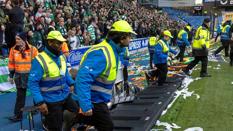GLASGOW, SCOTLAND - MARCH 08: Stewards head onto the pitch as fans storm the pitch at full time during a Scottish Gas Scottish Cup Quarter-Final match between Rangers and Celtic at Ibrox Stadium, on March 08, 2026, in Glasgow, Scotland. (Photo by Craig Williamson / SNS Group)