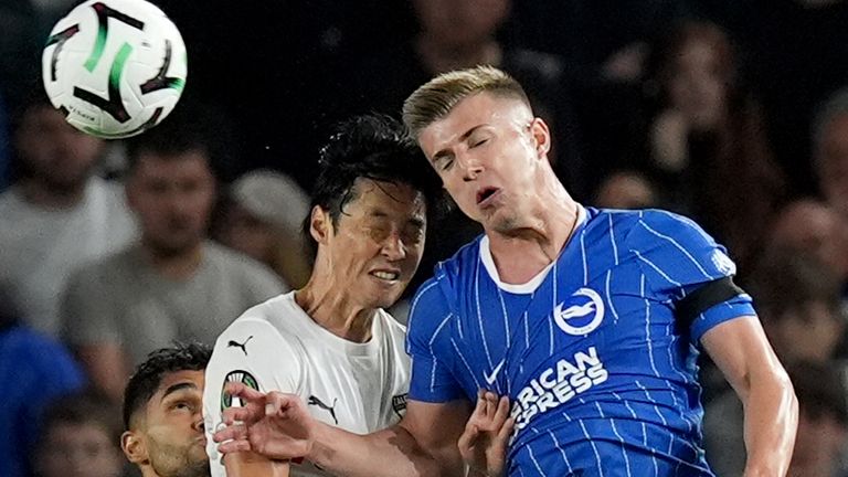 Kauno Zalgiris' Yukiyoshi Karashima (left) and Brighton and Hove Albion's Costinha battle for the ball