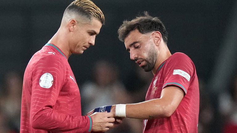 Portugal's Cristiano Ronaldo, left, hands the captain Armando to teammate Bruno Fernandes after being substituted during the Nations League soccer match between Portugal and Wales in Lisbon, Thursday, Sept. 24, 2026. (AP Photo/Armando Franca)