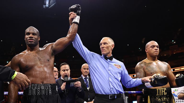 Dubois has his hand raised in victory