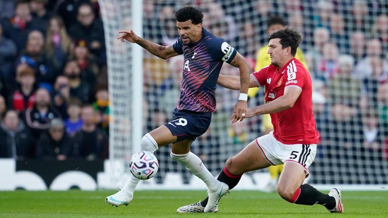 Spurs' Dominic Solanke is challenged by Man Utd's Harry Maguire (AP Photo/Dave Thompson)