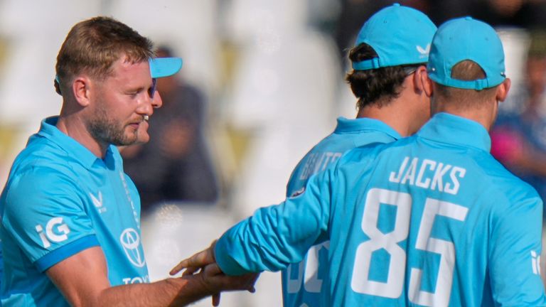 England's Gus Atkinson, left, celebrates with teammates after taking the wicket of Pakistan's Saad Baig
