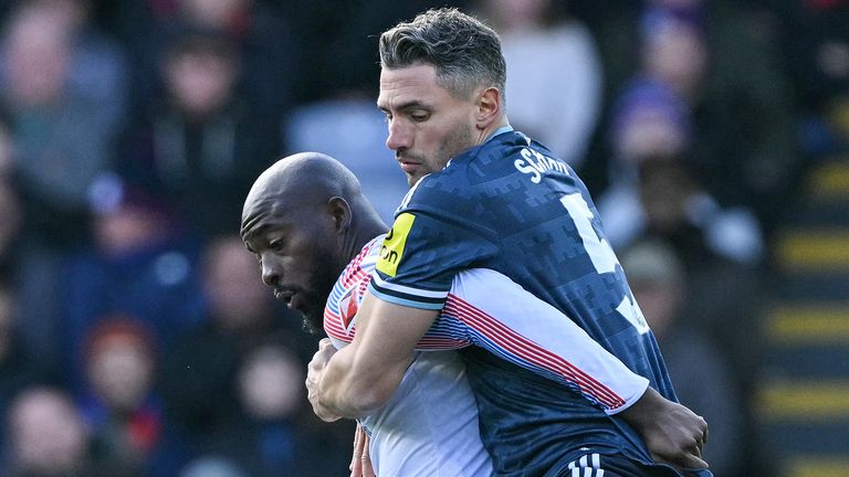 Jean-Philippe Mateta is challenged by Fabian Schar