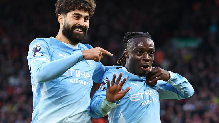Jeremy Doku celebrates after doubling Man City's lead