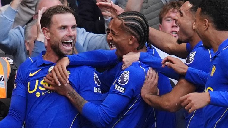 Jordan Henderson celebrates with his team-mates after scoring Chelsea's fifth