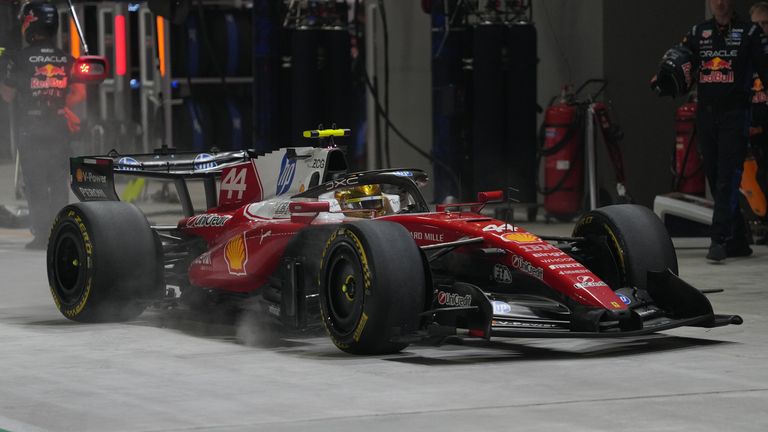 Ferrari driver Lewis Hamilton of Britain arrives for a pit service during the Singapore Formula One Grand Prix race in Singapore, Sunday, Oct. 11, 2026. (AP Photo/Ng Han Guan, Pool)