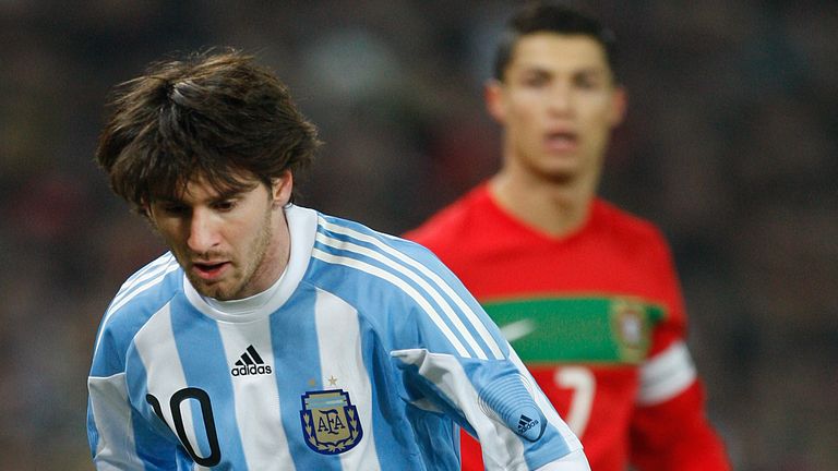 Lionel Messi is watched by Cristiano Ronaldo during a match between Argentina and Portugal at the Stade Geneve in Switzerland