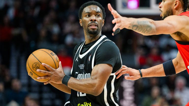 London Lions guard Keenan Evans, left, looks for an opening past Portland Trail Blazers forward Toumani Camara (AP Photo/Molly J. Smith)