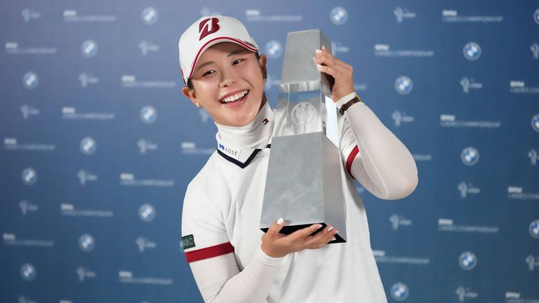 Yuri Yoshida of Japan celebrates with the winner's trophy following the final round of the LPGA BMW Ladies Championship at the Pine Beach Golf Links, in Haenam, South Korea, Sunday, Oct. 25, 2026. (AP Photo/Lee Jin-man)