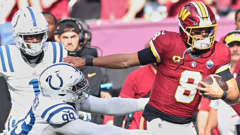 Washington Commanders quarterback Marcus Mariota (8) is tackled by Indianapolis Colts defensive tackle DeForest Buckner (99) during an NFL football game in London, Sunday, Oct. 4, 2026. (AP Photo/Ian Walton)