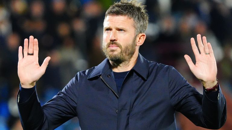 Man Utd head coach Michael Carrick holds his hands up to apologise to supporters after their 4-1 defeat by Como