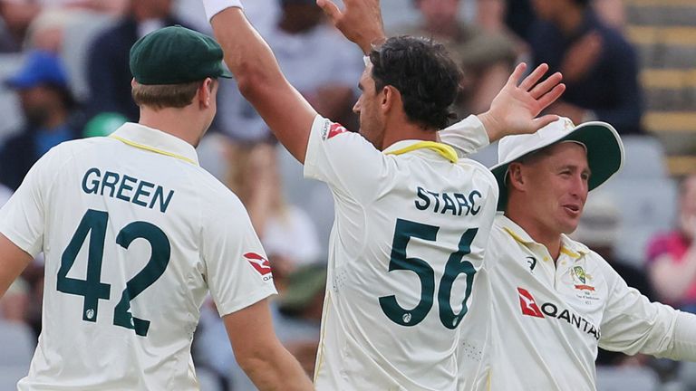 Australia's Mitchell Starc, center, celebrates with teammates the wicket of South Africa's Marco Jansen on day one of the third cricket Test