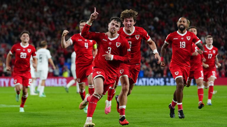 Neco Williams celebrates Wales' winning goal