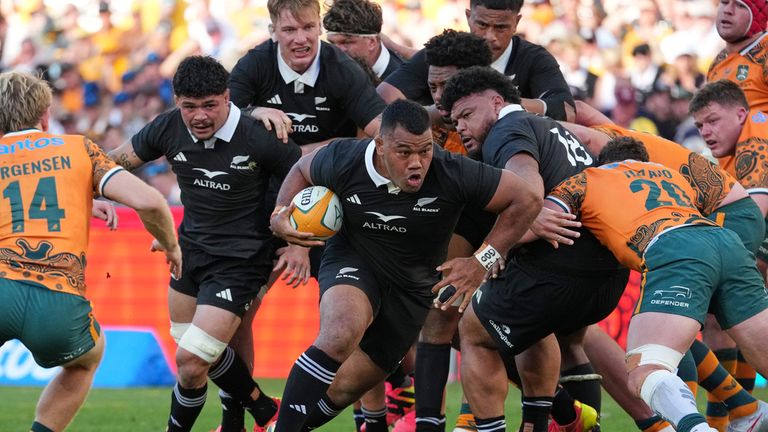 New Zealand's Samisoni Taukei'aho, center, makes a run against Australia's Max Jorgensen, left, during the Bledisloe Cup rugby union test in