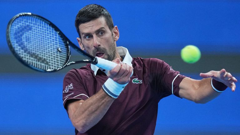 Novak Djokovic, of Serbia, returns a ball to, Alex De Minaur, of Australia, during the men's singles final match at the China Open tennis to