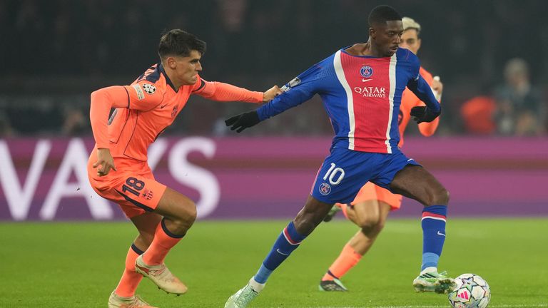 PSG's Ousmane Dembele, right, is challenged by Barcelona's Gerard Martin during the Champions League opening phase soccer match between Paris Saint-Germain and FC Barcelona in Paris, Tuesday, Oct. 20, 2026. (AP Photo/Thibault Camus)
