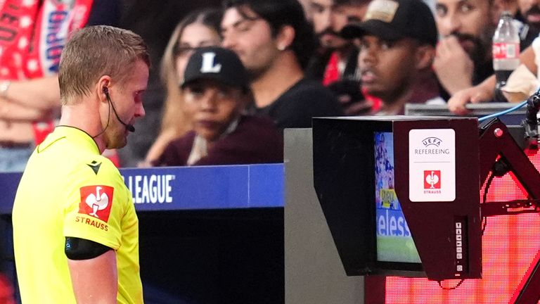 Referee Glenn Nyberg at the monitor before deciding to disallow Atletico's second goal 