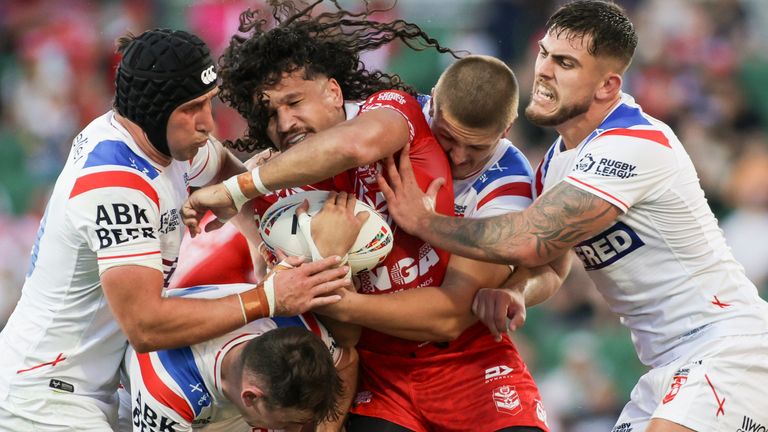 Tonga's Dallin Watene-Zelezniak is tackled by England's Victor Radley, Harry Smith, Sam Walters and Brad O'Neill