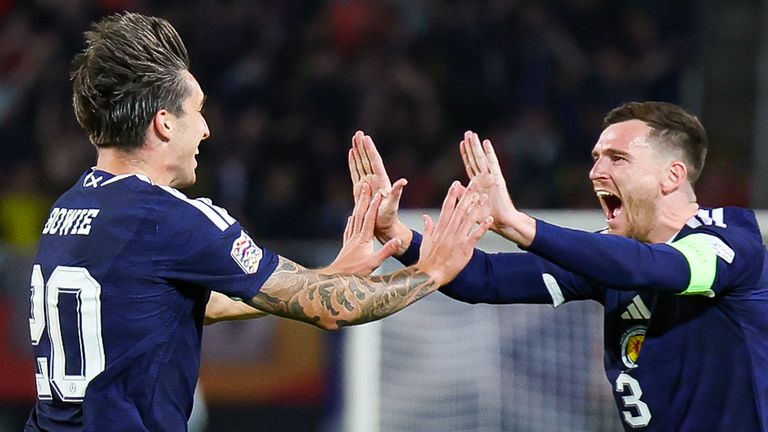 Kieron Bowie (L) celebrates his first Scotland goal with captain Andy Robertson