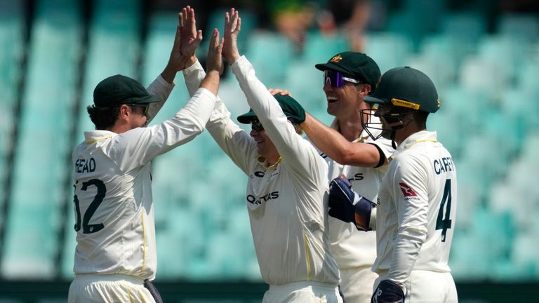 Australia's Steven Smith, second left, celebrates with his teammates after taking a catch on day three