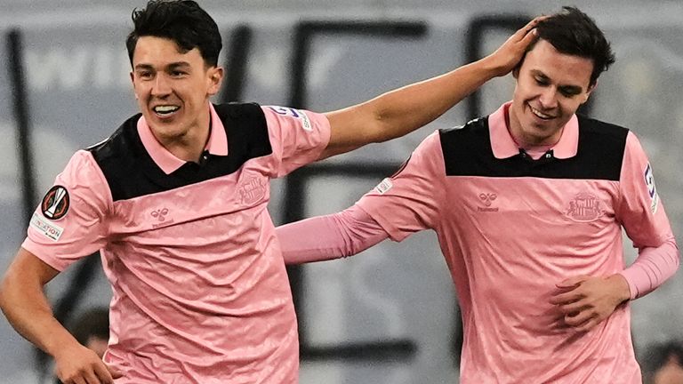 Sunderland's Luke O'Nien, left, and Timor Tutierov celebrate their side's opening goal during the Europa League opening phase soccer match between Lech Poznan and Sunderland in Poznan, Poland, Thursday, Oct. 22, 2026. (AP Photo/Piotr Hawalej)