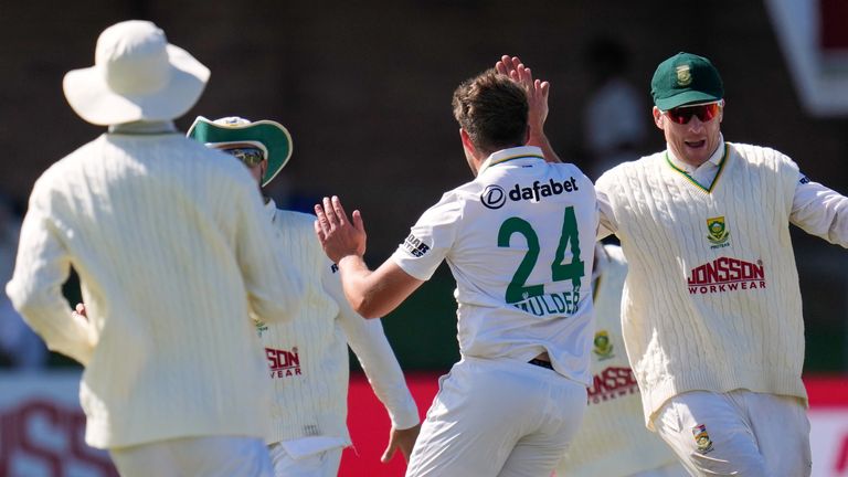 South Africa's Wiaan Mulder, center, celebrates with teammates the wicket of Australia's Scott Boland 